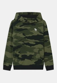 Sudadera de camuflaje en tonos verdes, con un bolsillo tipo canguro y puños negros. Presenta un pequeño logo de alce blanco en el pecho. Tejido de mezcla de algodón.