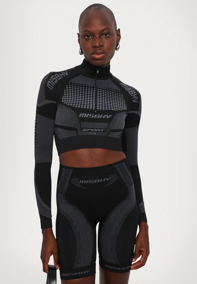 Black athletic set with long-sleeve crop top and high-waisted shorts; features textured patterns, logo accents, and a fitted design.
