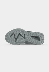 Shoe sole with textured zigzag and herringbone tread pattern in gray rubber, displayed flat on a neutral background.