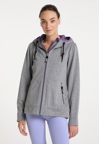 Giacca grigia con zip e cappuccio viola, dotata di due tasche frontali, cordini e una superficie liscia. Adatta per un abbigliamento casual.