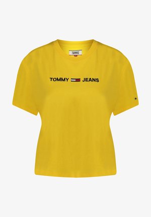 Żółta bawełniana koszulka z krótkim rękawem, z haftowanym logo "TOMMY JEANS" w czerni z czerwonymi i białymi akcentami na klatce piersiowej.