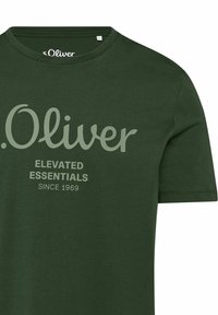 Dark green T-shirt with short sleeves, crew neck, and text "s.Oliver Elevated Essentials Since 1969" on the front.
