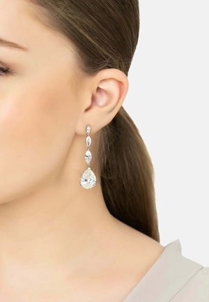 Teardrop earrings in silver-colored metal featuring clear, sparkling crystals in a layered design, with a pear-shaped centerpiece.