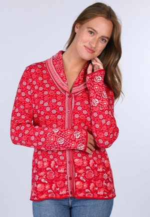 Red patterned jacket featuring floral designs, a shawl collar, and button closure. Made of soft material with ribbed cuffs and hem.