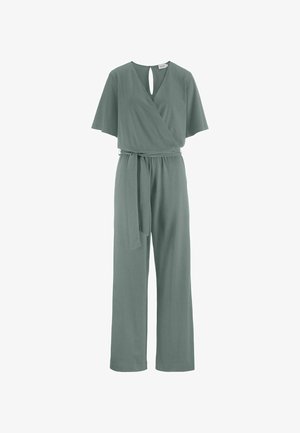 Short-sleeve teal jumpsuit with wrap V-neck, keyhole back, wide legs, and matching fabric belt tied at the waist.