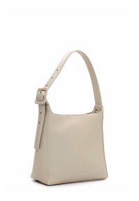 Beige leather shoulder bag with a wide strap, square shape, smooth texture, and a minimalistic design featuring a gold-colored accent.