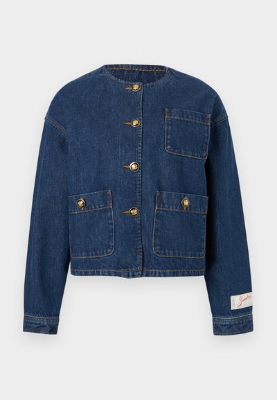 Σκούρο μπλε τζιν μπουφάν με στρογγυλή λαιμόκοψη, τέσσερα χρυσά κουμπιά, τρεις μπροστινές τσέπες και μια μικρή υφασμάτινη ετικέτα στη μανσέτα του μανικιού.