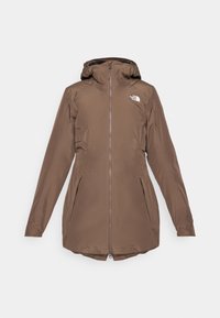 Buitenbroek met een capuchon, voorrits, twee zijzakken en logo op de borst. Glad textuur, middellange ontwerp.