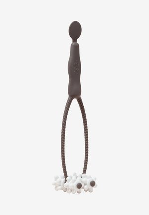 Brown silicone tool with a looped grip and a round top. White textured attachments resembling flowers with brown centers at the bottom.