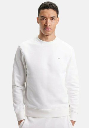 Sweatshirt blanc à col rond, avec des poignets et un ourlet côtelés. Présente un petit logo sur la poitrine. Fabriqué en tissu doux avec une texture lisse.