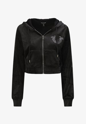 Zwarte cropped hoodie van zachte fluwelen stof, met lange mouwen, een ritssluiting aan de voorkant en een rhinestone-logo op de linkerborst. Twee voorzakken.