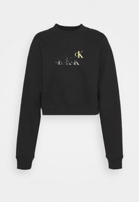 Zwarte cropped sweatshirt met lange mouwen, een ronde hals en een meerkleurige logo-print met gelaagde tekst in zilver en gele accenten.