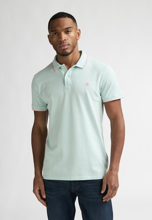 Poloshirt aus hellgrünem Baumwollstoff mit rosa Kragen- und Ärmelakzenten, mit kleinem Logo auf der Brust. Lässige Passform.
