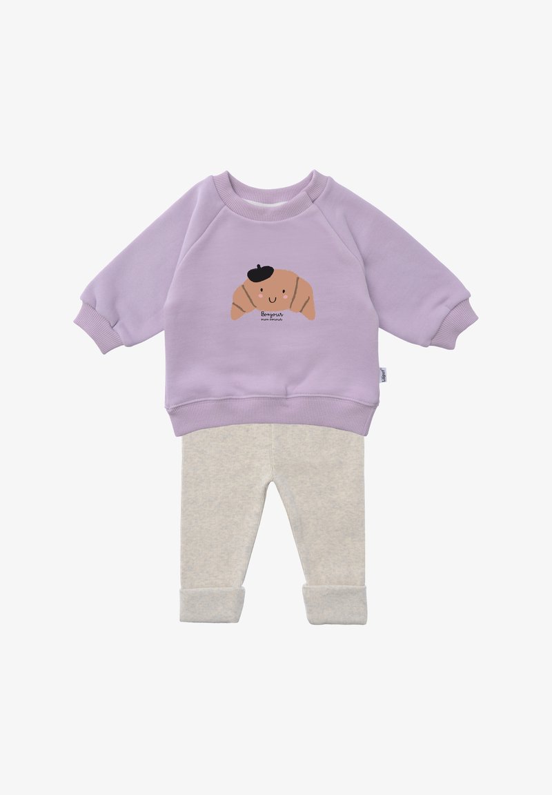 Lilac sweatshirt with a croissant graphic and beige pajama pants. The outfit features ribbed cuffs and soft, textured fabric for comfort.