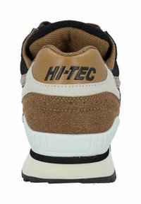 Brown and black sneaker featuring a textured suede and mesh upper, white midsole, and "HI-TEC" logo on the heel. Rubber outsole.