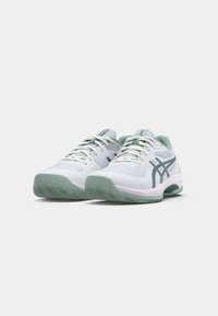 White athletic shoes with light green accents, mesh upper, textured sole, and contrasting laces. Features logo on side and heel.