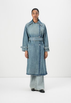 Denim trench coat with a belted waist, long sleeves, and oversized collar. Light blue wash with button closures and frayed hem details.