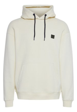 Cream-colored hoodie made of soft fabric, featuring a drawstring hood, front pocket, and a small logo patch on the left chest.
