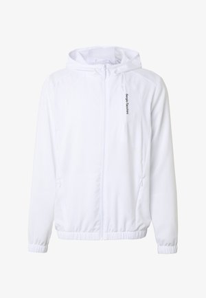 Hvid hættejakke med frontlynlås, elastiske manchetter og kant samt lodret brystlomme med lynlås med "Sergio Tacchini"-mærket.