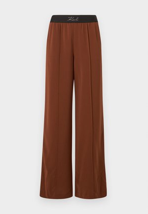 Weit geschnittene Hosen aus einem satten braunen Stoff mit einem elastischen schwarzen Bund. Mit vertikalen Nähten für einen maßgeschneiderten Look und einer glatten Textur.