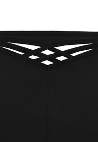 Černý top s křížově šněrovacím panelem na zádech, vyrobený z hladkého, elastického materiálu a jednoduchých, čistých linií.