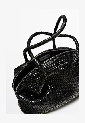 Black braided leather handbag with a textured surface, featuring two intertwined handles and a silver zip closure at the top.