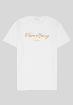 Balta medvilnės marškinėliai su auksiniu užrašu "Palm Spring" ir "California Love Eighty Five" žemiau, laisvas kirpimas, apvalus kaklas.
