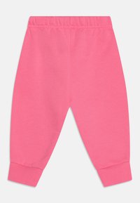 Rosa Baumwoll-Jogginghosen mit elastischem Bund, gerippten Bündchen und glatter Textur. Entwickelt für Komfort mit einem lockeren Schnitt.