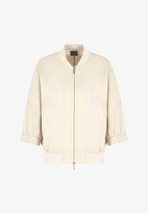 Giacca bomber beige chiaro con zip frontale, polsini elasticizzati, tasche laterali e orlo a coste. Tessuto liscio e durevole con una vestibilità rilassata.