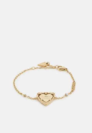 Bracciale in oro con un ciondolo a forma di cuore inciso e quattro piccole pietre trasparenti, unito da una catena con accenti incisi.