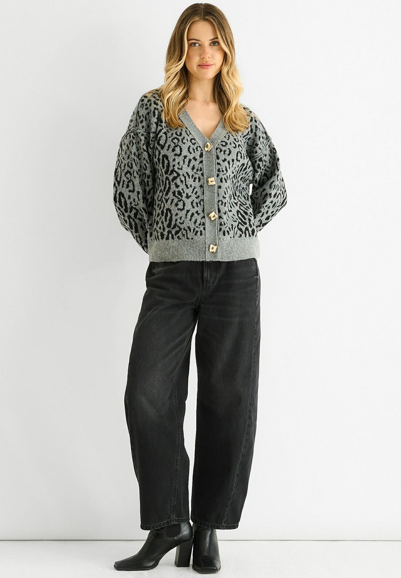 Gray cardigan with black leopard print, V-neck, and five gold buttons at the front. Paired with black jeans and ankle boots.