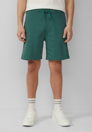 Shorts en mélange de coton vert avec une taille élastique et un cordon de serrage. Longueur genou avec une texture lisse et des poches latérales.