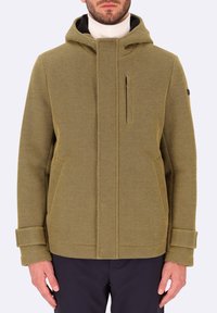 Giacca verde a trama con cappuccio, dotata di tasca frontale con zip, tasche laterali e polsini arrotolati. Realizzata in materiale tessuto con un motivo geometrico.
