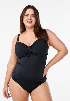 Svart baddräkt i ett stycke med en veckad front och knutdetalj, justerbara axelremmar och ett mjukt, stretchy tyg för en figurnära look.