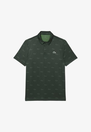 Polo shirt verde scuro con un sottile motivo all-over del logo Lacoste, maniche corte e colletto classico. Realizzato in tessuto liscio e traspirante.