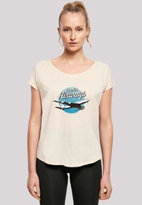 Light cream short-sleeve t-shirt with a rounded neckline featuring a blue and black graphic of an airplane and "Pan Am Airways" text.