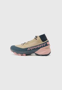 Beige and navy hiking shoe with a textured upper, pink accents, and a rugged sole. Features a lace closure and branding on the side.
