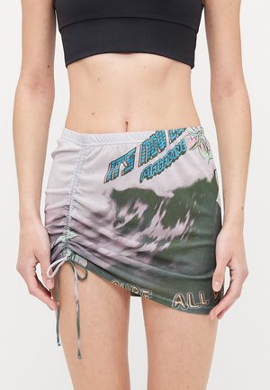 Ruched mini skirt in soft fabric, featuring a gradient pattern of green and gray, with a printed design that includes text and floral accents.