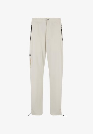 Beige lightweight pants with an elastic waistband, front zipper, side zip pockets, and adjustable drawstrings at the cuffs.