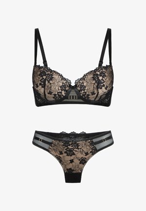 Schwarzer Spitzen-BH und passender Tanga mit transparentem nude-farbenem Futter, verfügt über florale Muster, verstellbare Träger und goldfarbene Akzente.