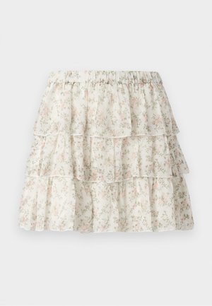 Vit kjol med ett lager av volanger och rynkor. Har ett delikat blommönster i rosa och grönt. Elastisk midja för komfort.