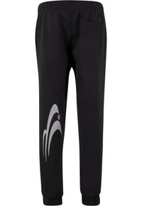 Black sweatpants with an elastic waistband, side pocket, and a large gray graphic design on the left leg. Fabric appears smooth and soft.