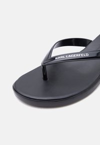 Μαύρο σανδάλι τύπου σαγιονάρα με λουράκι-δακτυλίδι που φέρει το λογότυπο "KARL LAGERFELD" σε λευκό στο πάνω μέρος.