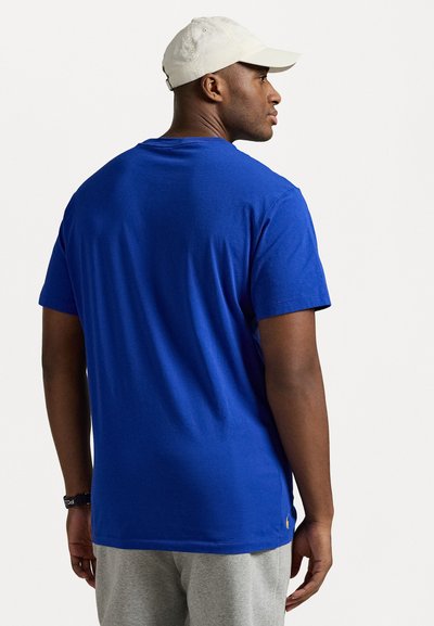 Blue short-sleeve t-shirt in cotton blend fabric, featuring a straight cut and simple design. Visible logo detail near the hem.