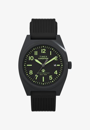 Black Timex Expedition watch with a round face, luminous green hour markers, black rubber strap, and water resistance up to 50m.