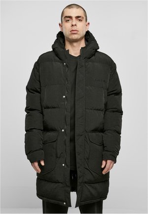 Svart pufferjakke med hette, med kviltet design, trykknapper og frontlommer. Teksturert stoff med subtil glans.