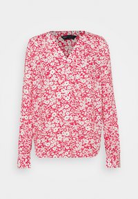 Blusa a maniche lunghe con motivo floreale. Presenta una combinazione di colori rosso e bianco con piccoli fiori e una scollatura a V. Tessuto leggero.