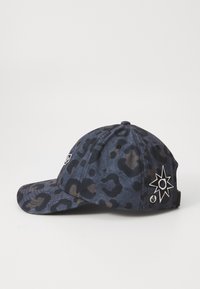 Cappellino da baseball di colore blu scuro con motivo a stampa leopardata. Presenta un logo ricamato bianco e un dettaglio a stella, con visiera curva e strap regolabile.