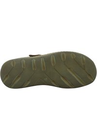 Shoe sole with a textured, rubber material featuring a hexagonal pattern and elongated grip details, primarily in light tan and beige colors.