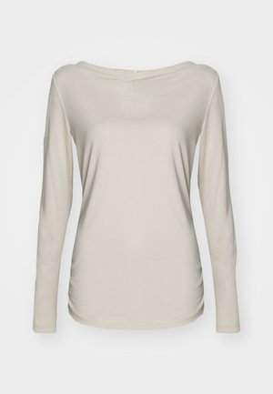 Ilga rankovėm bežinė palaidinė su plačiu laivagalio iškirpimu, pagaminta iš lengvos medžiagos su švelniu tekstūra ir priglundančia forma.